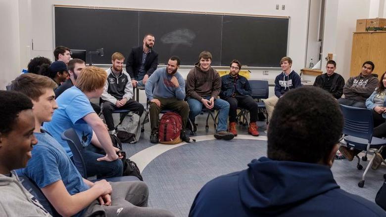 学生s sitting in a circle in a classroom